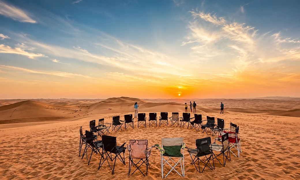 Desert camp chairs arranged for guests after an Abu Dhabi sunrise safari