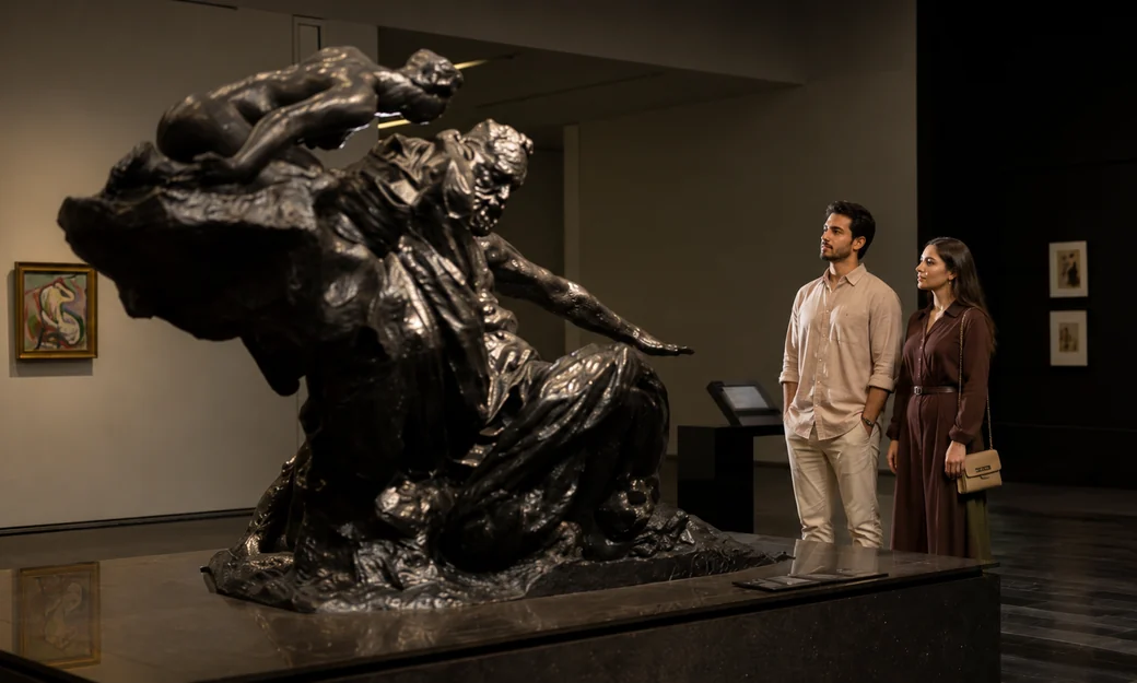 Visitors viewing a sculpture at Louvre Abu Dhabi