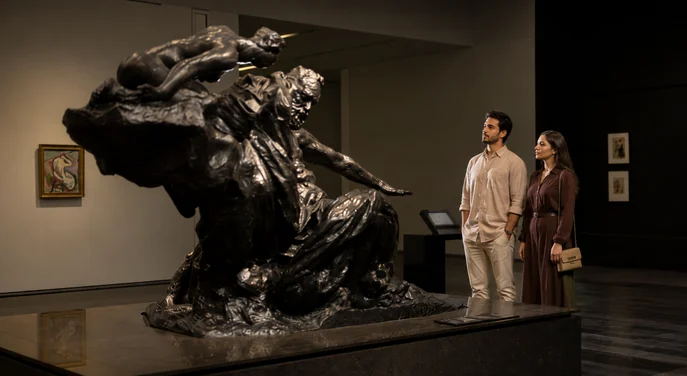 Visitors viewing a monumental sculpture inside Louvre Abu Dhabi