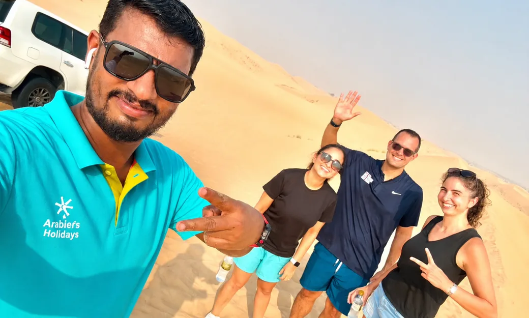 Arabiers guide taking a photo with morning desert safari guests in Abu Dhabi