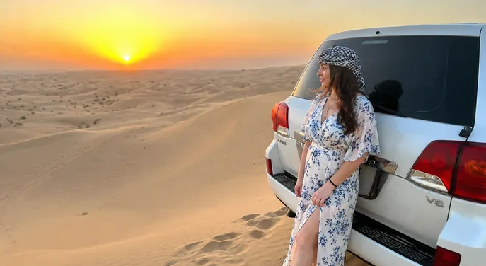 Traveller beside a private 4x4 during an Abu Dhabi sunrise desert safari
