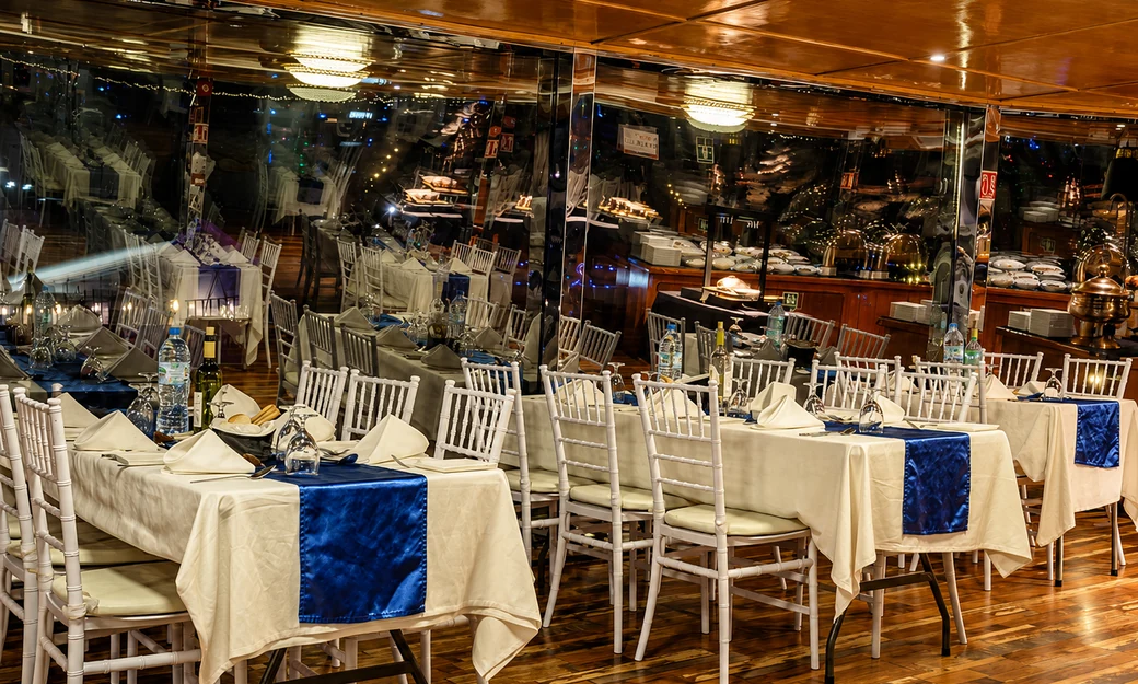 Air-conditioned lower deck dining area aboard the Yas Island dinner dhow