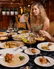 Guests enjoying dinner together aboard a traditional Yas Marina dhow