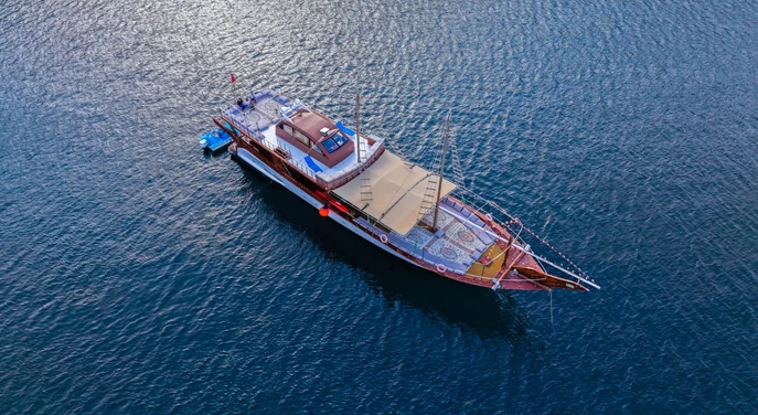Aerial view of a traditional dhow on the blue waters of Musandam