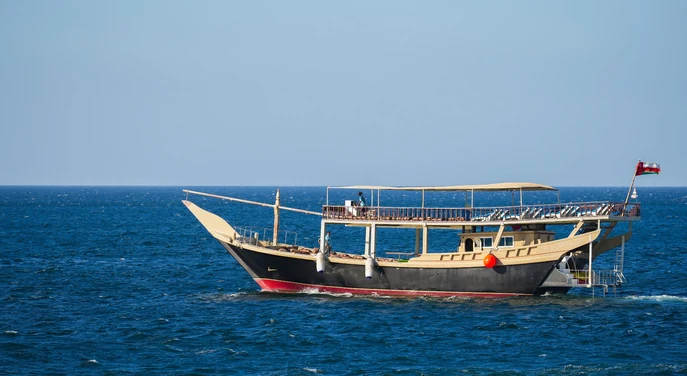 Traditional dhow sailing across the open sea near Musandam