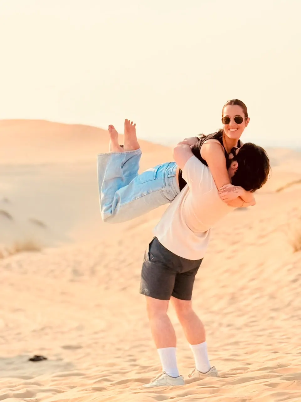 Couple celebrating on the dunes near Abu Dhabi