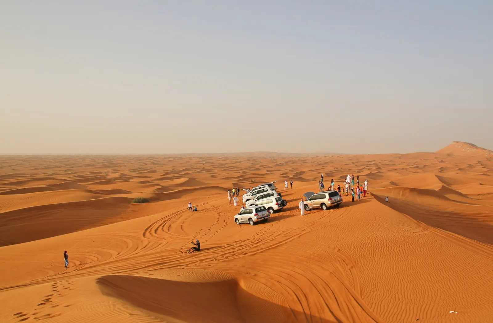 Private 4x4 desert safari vehicles on a dune top in Al Khatim, Abu Dhabi
