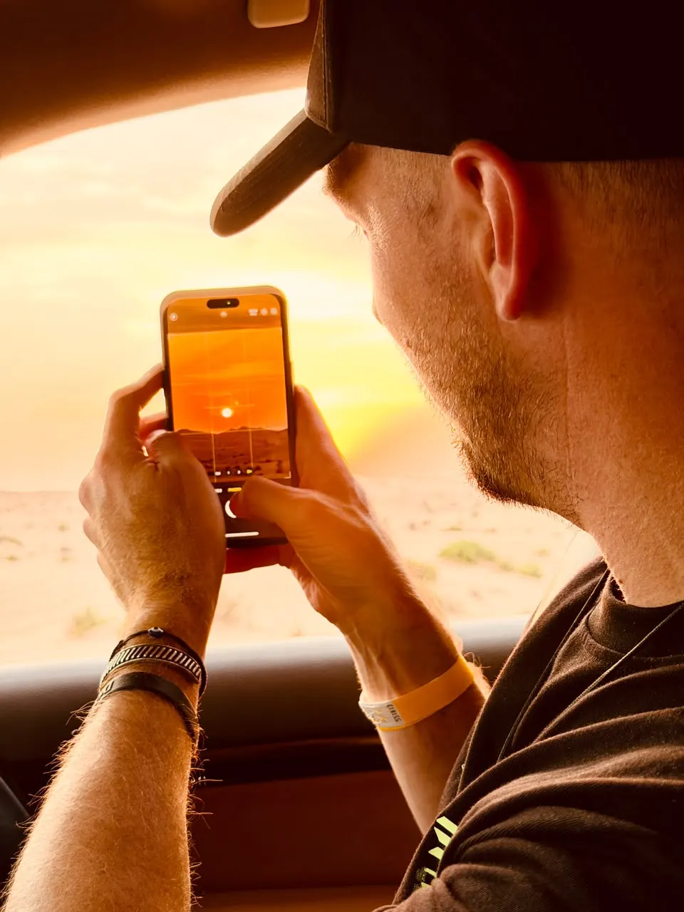 Guest photographing the desert sunset from the 4x4