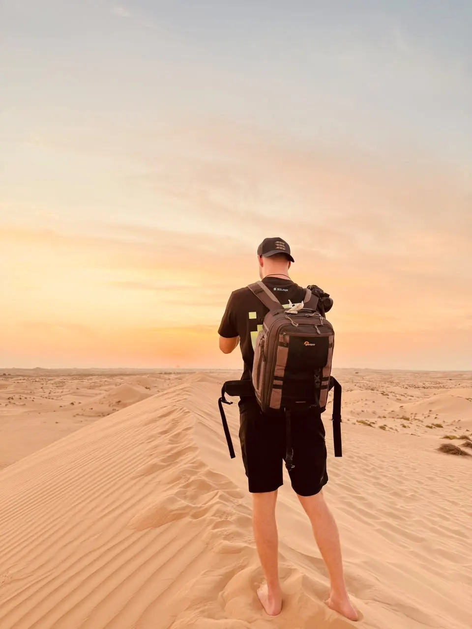 Guest photographing the sunset from a dune ridge in Abu Dhabi