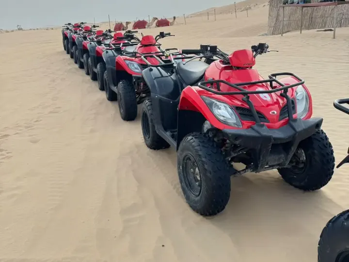 Red quad bikes lined up in daylight for the private morning quad bike adventure in Abu Dhabi