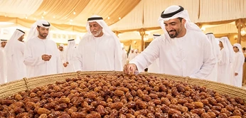 Emirati hosts sharing traditional dates during an Abu Dhabi cultural experience