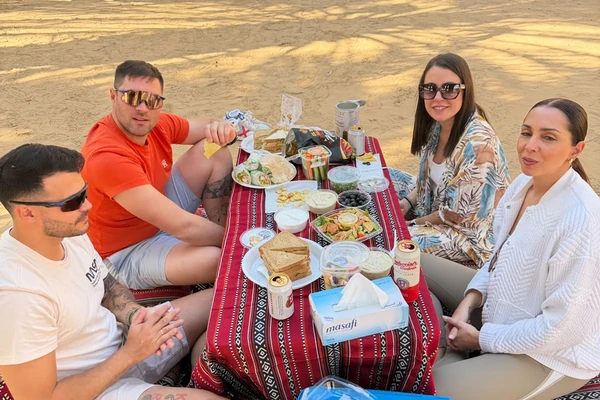 Guests enjoying a picnic in an Abu Dhabi palm oasis