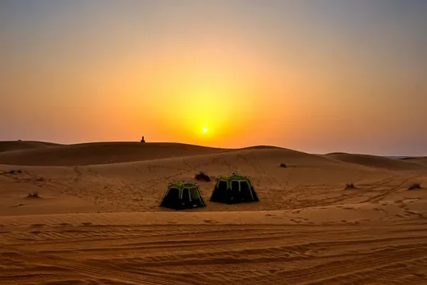 Tents set up in the Abu Dhabi desert at sunset
