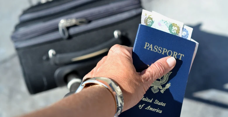Passport, return ticket and photograph laid out as UAE tourist visa document checklist
