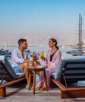 Albanian travellers relaxing by Dubai Creek Harbour with the Dubai skyline, UAE visa guide 2026