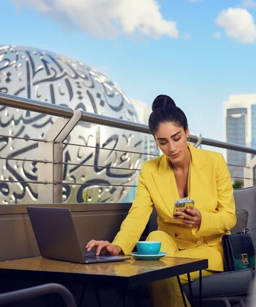 Traveller arranging Dubai travel insurance near Museum of the Future