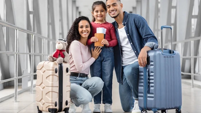 Family travelling with passports and luggage after receiving their Dubai tourist visa