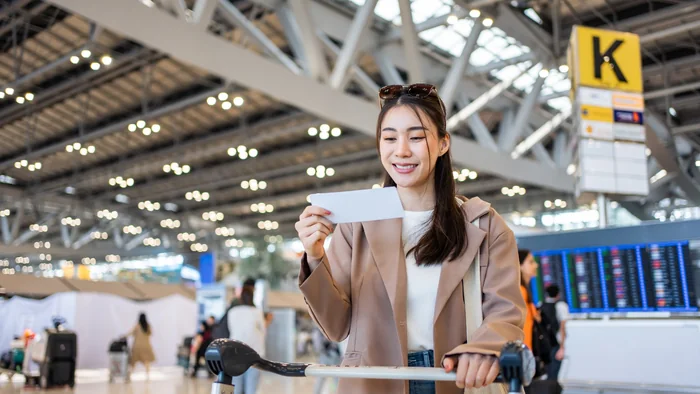 Traveller checking travel documents at the airport while preparing for a Dubai trip