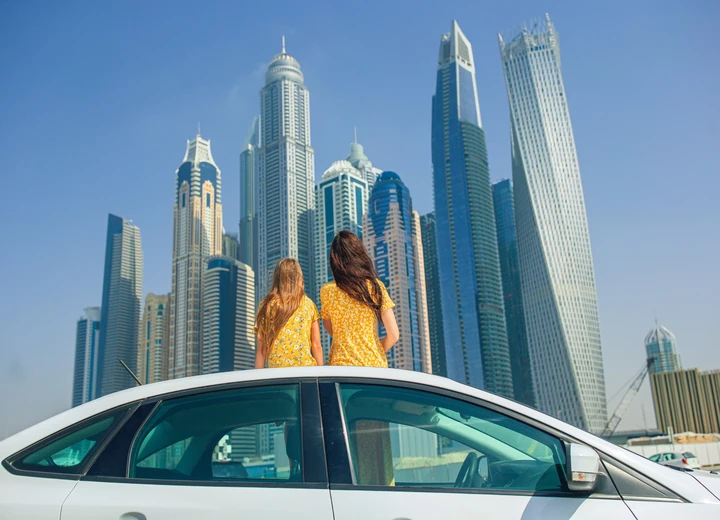 Traveller sitting in Downtown Dubai with Burj Khalifa in the background