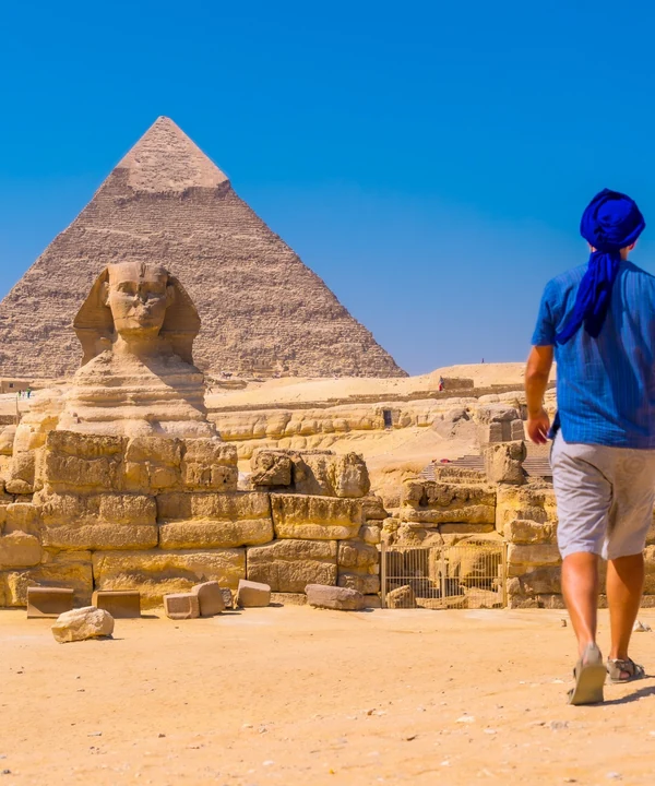Traveller visiting the Great Sphinx and Pyramids of Giza in Egypt