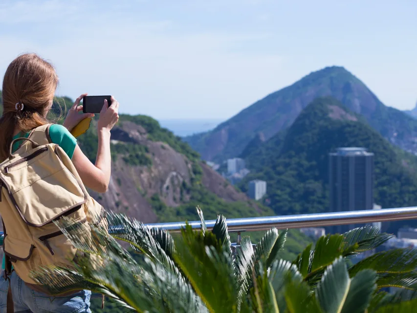 Traveller with a backpack photographing Rio de Janeiro during a Brazil trip from Dubai
