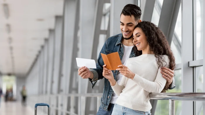 Couple checking passports and boarding pass before UAE travel