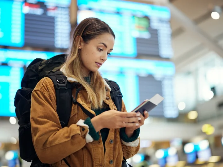 Traveller checking UAE visa status on a smartphone at the airport