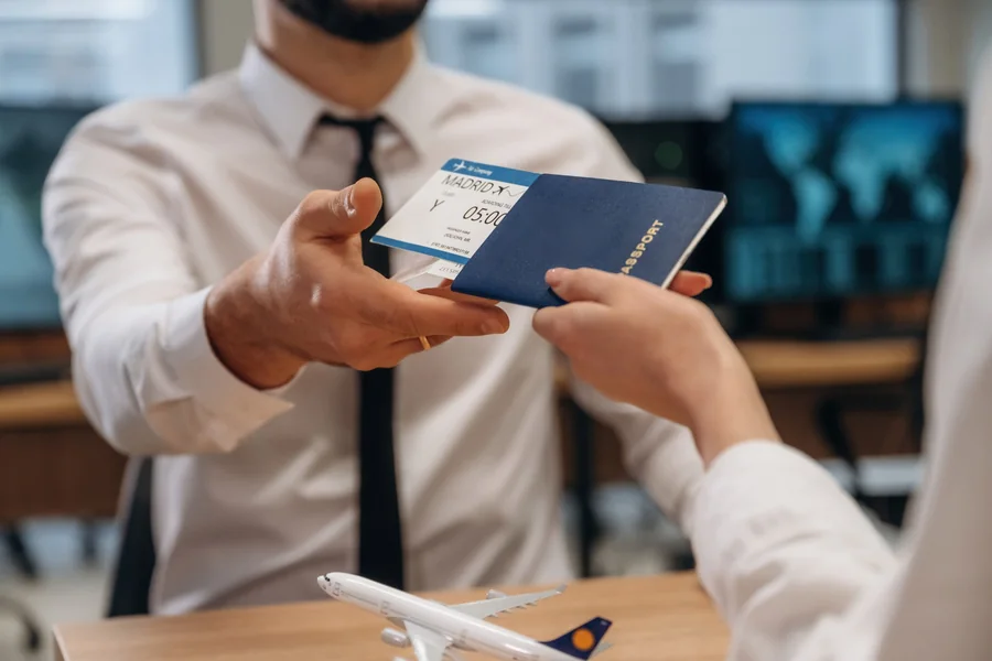 Traveller handing over a passport and travel documents for a UAE visa application