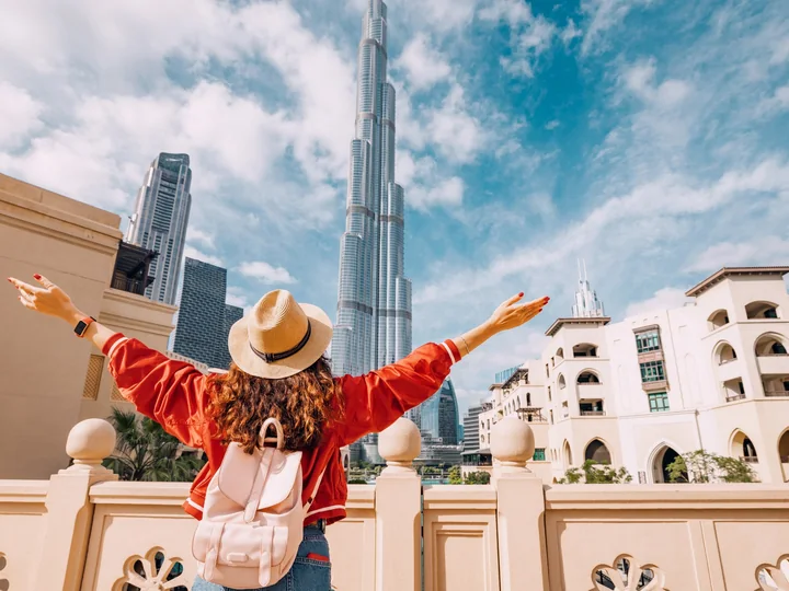 Traveller sitting in Downtown Dubai with Burj Khalifa in the background
