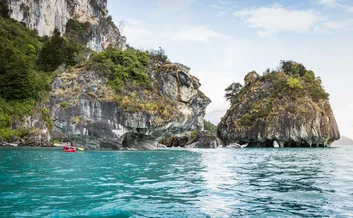Longtail boats beside limestone cliffs in Krabi, Thailand