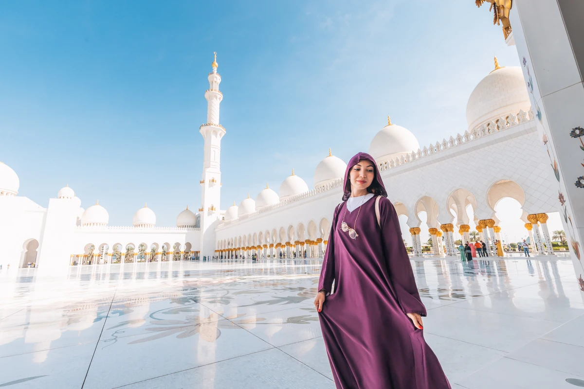 Female visitor wearing modest clothing at Sheikh Zayed Grand Mosque