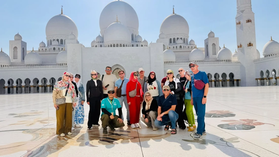 Family group in the courtyard of Sheikh Zayed Grand Mosque Abu Dhabi