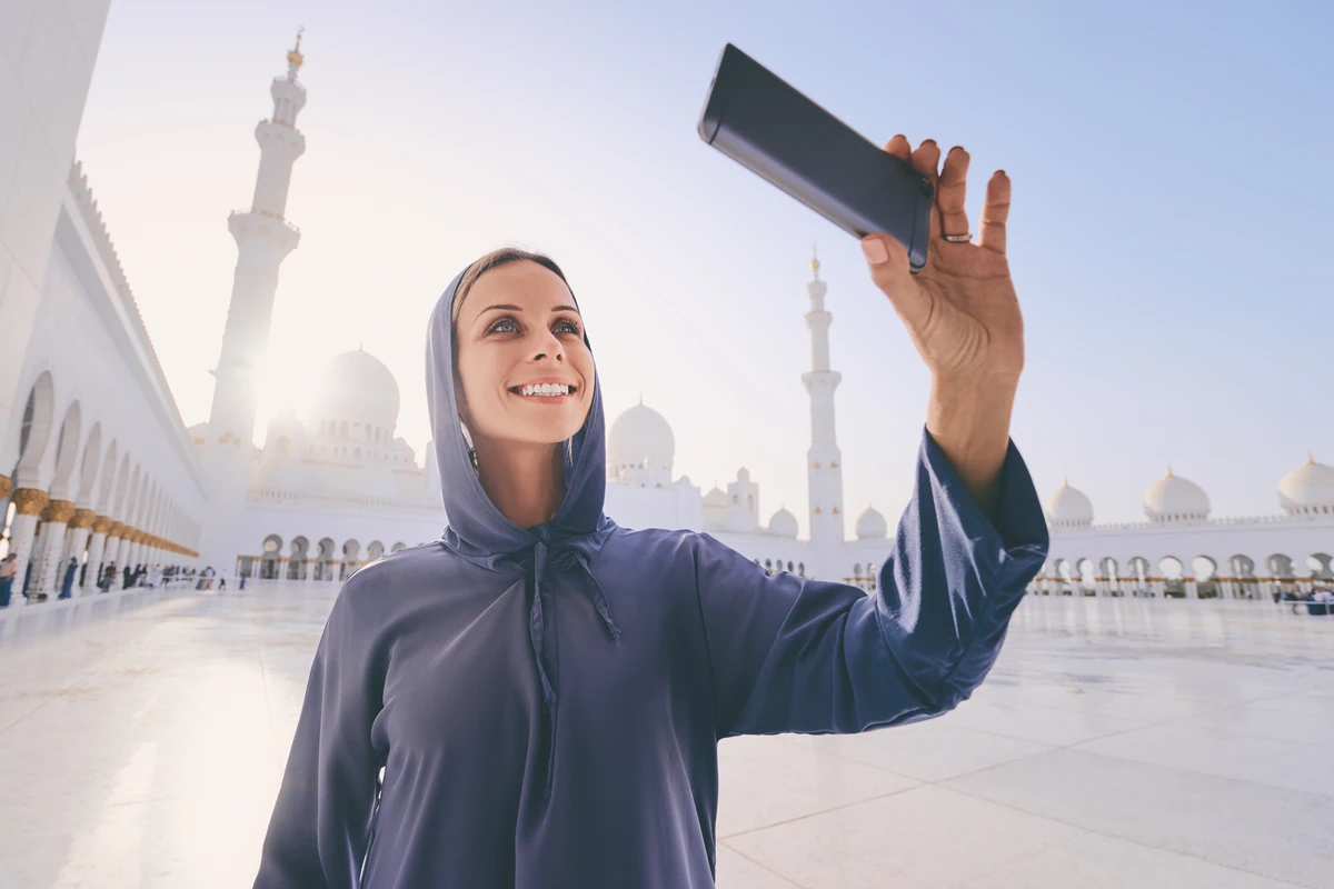 Visitor showing a mobile entry ticket at Sheikh Zayed Grand Mosque